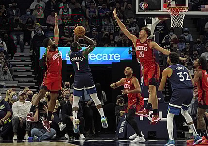 Oct 20, 2021; Minneapolis, Minnesota, USA; Minnesota Timberwolves forward Anthony Edwards (1) takes a jump shot as Houston Rockets forward David Nwaba (2) and center Alperen Sengun (28) defend during the first quarter at Target Center. Mandatory Credit: Nick Wosika-USA TODAY Sports