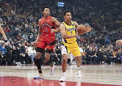 Oct 27, 2021; Toronto, Ontario, CAN; Indiana Pacers guard Malcolm Brogdon (7) controls the ball as Toronto Raptors forward Scottie Barnes (4) tries to defend during the first quarter at Scotiabank Arena. Mandatory Credit: Nick Turchiaro-USA TODAY Sports