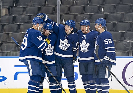 Jan 1, 2022; Toronto, Ontario, CAN; Toronto Maple Leafs right wing Ilya Mikheyev (65) celebrates scoring a goal with Toronto Maple Leafs center Jason Spezza (19) and Toronto Maple Leafs defenseman Rasmus Sandin (38) during the third period against the Ottawa Senators at Scotiabank Arena. Mandatory Credit: Nick Turchiaro-USA TODAY Sports