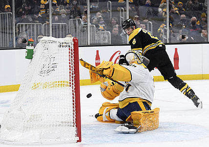 Jan 15, 2022; Boston, Massachusetts, USA;  Boston Bruins defenseman Mike Reilly (6) scores a goal past Nashville Predators goaltender Juuse Saros (74) during the first period at TD Garden. Mandatory Credit: Bob DeChiara-USA TODAY Sports
