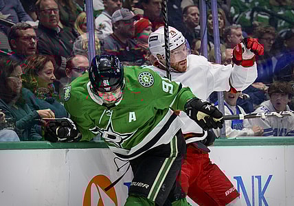 Nov 30, 2021; Dallas, Texas, USA; Dallas Stars center Tyler Seguin (91) checks Carolina Hurricanes defenseman Ian Cole (28) during the second period at the American Airlines Center. Mandatory Credit: Jerome Miron-USA TODAY Sports
