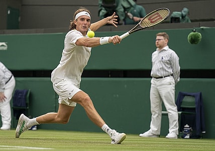 Jun 30, 2022; London, United Kingdom; Stefanos Tsitsipas (GRE) returns a shot during his match against Jordan Thompson (AUS) on day four at All England Lawn Tennis and Croquet Club. Mandatory Credit: Susan Mullane-USA TODAY Sports