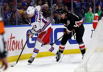 Mar 11, 2023; Buffalo, New York, USA;  New York Rangers left wing Alexis Lafreni  re (13) controls the puck as Buffalo Sabres defenseman Owen Power (25) defends during the first period at KeyBank Center. Mandatory Credit: Timothy T. Ludwig-USA TODAY Sports