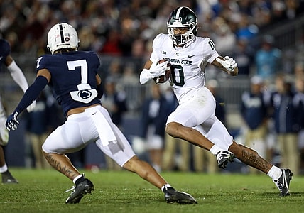 Nov 26, 2022; University Park, Pennsylvania, USA; Michigan State Spartans wide receiver Keon Coleman (0) runs the ball against Penn State Nittany Lions safety Jaylen Reed (7) during the fourth quarter at Beaver Stadium. Penn State won 35-16. Mandatory Credit: Matthew OHaren-USA TODAY Sports
