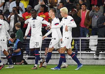 Oct 17, 2023; Nashville, Tennessee, USA; United States forward Tim Weah (21) celebrates with midfielder Gio Reyna (7) after a goal during the first half against Ghana at GEODIS Park. Mandatory Credit: Christopher Hanewinckel-USA TODAY Sports