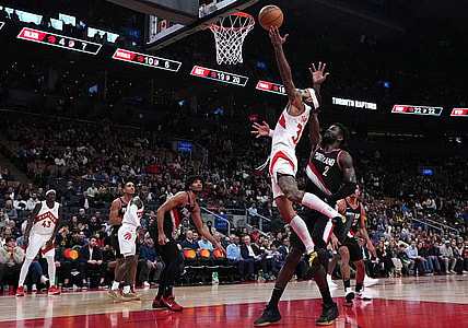 Oct 30, 2023; Toronto, Ontario, CAN; Toronto Raptors guard Gary Trent Jr. (33) drives to the basket over Portland Trail Blazers center Deandre Ayton (2) during the fourth quarter at Scotiabank Arena. Mandatory Credit: Nick Turchiaro-USA TODAY Sports