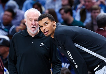 Dec 23, 2023; Dallas, Texas, USA; San Antonio Spurs head coach Gregg Popovich speaks with San Antonio Spurs center Victor Wembanyama (1) before the game against the Dallas Mavericks at American Airlines Center. Mandatory Credit: Kevin Jairaj-USA TODAY Sports