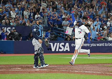 Sep 29, 2023; Toronto, Ontario, CAN; Toronto Blue Jays first baseman Vladimir Guerrero Jr. (27) runs to home plate scoring a run against the Tampa Bay Rays during the sixth inning at Rogers Centre. Mandatory Credit: Nick Turchiaro-USA TODAY Sports
