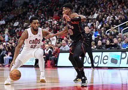 Feb 10, 2024; Toronto, Ontario, CAN; Cleveland Cavaliers guard Donovan Mitchell (45) controls the ball as Toronto Raptors guard Ochai Agbaji (30) tries to defend during the second quarter at Scotiabank Arena . Mandatory Credit: Nick Turchiaro-USA TODAY Sports