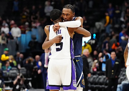 Feb 14, 2024; Denver, Colorado, USA; Sacramento Kings guard De'Aaron Fox (5) and Denver Nuggets forward Peyton Watson (8) following the game at Ball Arena. Mandatory Credit: Ron Chenoy-USA TODAY Sports