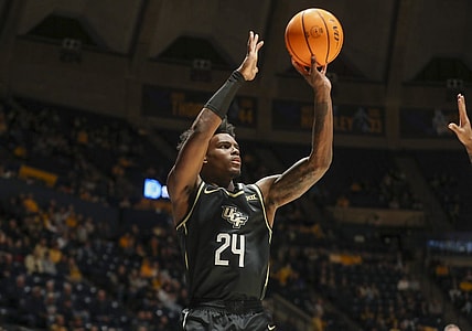 Feb 20, 2024; Morgantown, West Virginia, USA; UCF Knights guard Jaylin Sellers (24) shoots a three pointer during the first half against the West Virginia Mountaineers at WVU Coliseum. Mandatory Credit: Ben Queen-USA TODAY Sports