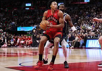 Feb 28, 2024; Toronto, Ontario, CAN; Toronto Raptors forward Scottie Barnes (4) controls the ball as Dallas Mavericks guard Kyrie Irving (11) tries to defend during the fourth quarter at Scotiabank Arena. Mandatory Credit: Nick Turchiaro-USA TODAY Sports