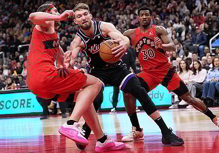 Mar 20, 2024; Toronto, Ontario, CAN; Sacramento Kings forward Domantas Sabonis (10) controls the ball as Toronto Raptors forward Kelly Olynyk (41) tries to defend during the second quarter at Scotiabank Arena. Mandatory Credit: Nick Turchiaro-USA TODAY Sports
