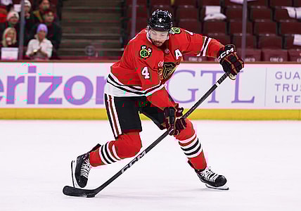 CHICAGO, IL - JANUARY 26: Seth Jones #4 of the Chicago Blackhawks controls the puck during the third period against the Minnesota Wild on January 26, 2025 at the United Center in Chicago, Illinois. (Photo by Melissa Tamez/Icon Sportswire)