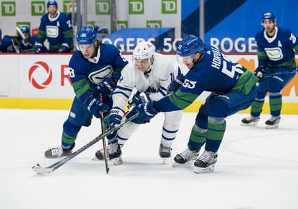Mar 6, 2021; Vancouver, British Columbia, CAN; Vancouver Canucks forward Adam Gaudette (96) and  forward Bo Horvat (53) check Toronto Maple Leafs forward  Zach Hyman (11) in the third period at Rogers Arena. Canucks won 4-2. Mandatory Credit: Bob Frid-USA TODAY Sports