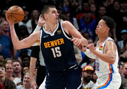 Mar 26, 2022; Denver, Colorado, USA; Denver Nuggets center Nikola Jokic (15) passes the ball over Oklahoma City Thunder forward Isaiah Roby (22) in the fourth quarter at Ball Arena. Mandatory Credit: Ron Chenoy-USA TODAY Sports
