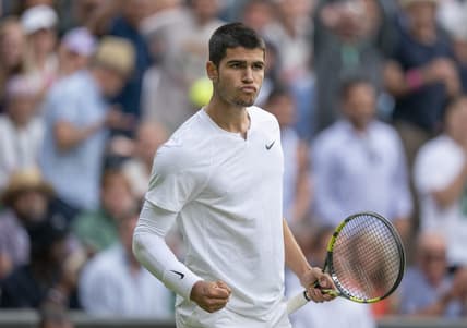 Jul 3, 2022; London, United Kingdom; Carlos Alcaraz (ESP) reacts to a point during his match against Jannik Sinner (ITA) on day seven at All England Lawn Tennis and Croquet Club. Mandatory Credit: Susan Mullane-USA TODAY Sports