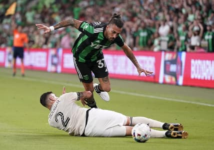 Aug 26, 2022; Austin, Texas, USA; Los Angeles FC defender Franco Escobar (2) slide tackles Austin FC forward Maximiliano Urruti (37) during the second half at Q2 Stadium. Mandatory Credit: Scott Wachter-USA TODAY Sports