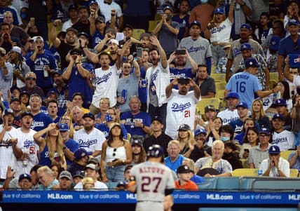 Spectators react toward Houston Astros second baseman Jose Altuve (27) after he flies out against the Los Angeles Dodgers during the third inning at Dodger Stadium. Mandatory Credit: Gary A. Vasquez-USA TODAY Sports