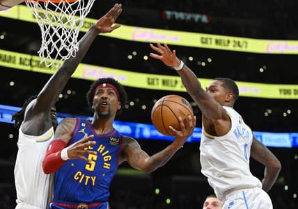 Oct 30, 2022; Los Angeles, California, USA;  Denver Nuggets guard Kentavious Caldwell-Pope (5) is defended by Los Angeles Lakers forward Wenyen Gabriel (35) and Los Angeles Lakers guard Lonnie Walker IV (4) as he drives to the basket in the first half at Crypto.com Arena. Mandatory Credit: Jayne Kamin-Oncea-USA TODAY Sports