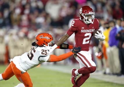 Nov 19, 2022; Norman, Oklahoma, USA;  Oklahoma Sooners running back Jovantae Barnes (2) runs the ball against Oklahoma State Cowboys safety Jason Taylor II (25)  in the second quarter at Gaylord Family-Oklahoma Memorial Stadium. Mandatory Credit: Sarah Phipps-USA TODAY Sports