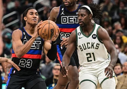Nov 2, 2022; Milwaukee, Wisconsin, USA; Detroit Pistons guard Jaden Ivey (23) looks for a shot against Milwaukee Bucks guard Jrue Holiday (21) in the fourth quarter at Fiserv Forum. Mandatory Credit: Benny Sieu-USA TODAY Sports