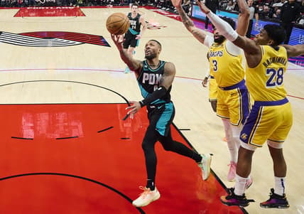 Feb 13, 2023; Portland, Oregon, USA; Portland Trail Blazers guard Damian Lillard (0) drives to the basket during the first half against Los Angeles Lakers forward Anthony Davis (3) and forward Rui Hachimura (28) at Moda Center. Mandatory Credit: Troy Wayrynen-USA TODAY Sports