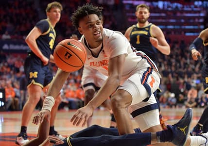 Mar 2, 2023; Champaign, Illinois, USA;  Illinois Fighting Illini guard Terrence Shannon Jr. (0) looks for the call as he drives the ball against Michigan Wolverines guard Kobe Bufkin (2) during the first half at State Farm Center. Mandatory Credit: Ron Johnson-USA TODAY Sports