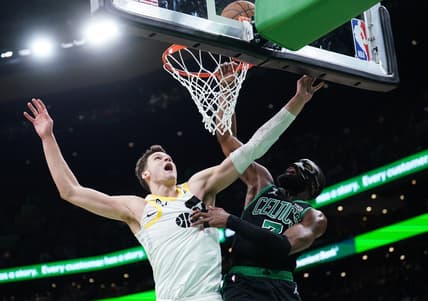 Mar 31, 2023; Boston, Massachusetts, USA; Boston Celtics guard Jaylen Brown (7) makes the basket against Utah Jazz center Walker Kessler (24) in the second quarter at TD Garden. Mandatory Credit: David Butler II-USA TODAY Sports