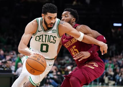 Dec 12, 2023; Boston, Massachusetts, USA; Boston Celtics forward Jayson Tatum (0) drives the ball against Cleveland Cavaliers guard Donovan Mitchell (45) in the second half at TD Garden. Mandatory Credit: David Butler II-USA TODAY Sports