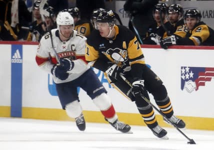 Jan 26, 2024; Pittsburgh, Pennsylvania, USA; Pittsburgh Penguins center Evgeni Malkin (71) moves the puck against Florida Panthers center Aleksander Barkov (16) during the second period at PPG Paints Arena. Mandatory Credit: Charles LeClaire-USA TODAY Sports