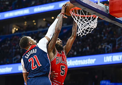 Jan 1, 2022; Washington, District of Columbia, USA; Washington Wizards center Daniel Gafford (21) fouls Chicago Bulls forward Derrick Jones Jr. (5) during the second half at Capital One Arena. Mandatory Credit: Brad Mills-USA TODAY Sports