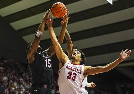 Feb 26, 2022; Tuscaloosa, Alabama, USA; Alabama Crimson Tide forward James Rojas (33) and South Carolina Gamecocks forward Wildens Leveque (15) go up for a rebound during first half at Coleman Coliseum. Mandatory Credit: Marvin Gentry-USA TODAY Sports