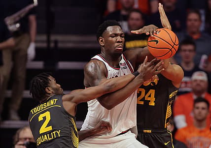 Mar 6, 2022; Champaign, Illinois, USA; Iowa Hawkeyes guard Joe Toussaint (2) and teammate Kris Murray (24) break up the ball in the hands of Illinois Fighting Illini center Kofi Cockburn (21) during the second half at State Farm Center. Mandatory Credit: Ron Johnson-USA TODAY Sports