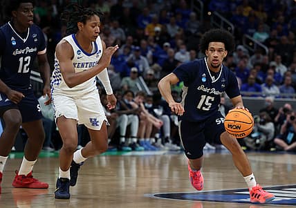 Mar 17, 2022; Indianapolis, IN, USA; Saint Peter's Peacocks guard Matthew Lee (15) dribbles the ball against Kentucky Wildcats guard Davion Mintz (10) during the first round of the 2022 NCAA Tournament at Gainbridge Fieldhouse. Mandatory Credit: Trevor Ruszkowski-USA TODAY Sports