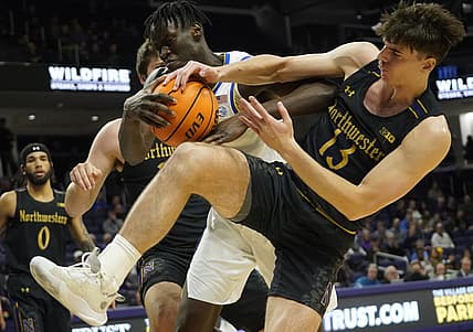 Nov 28, 2022; Evanston, Illinois, USA; Northwestern Wildcats guard Brooks Barnhizer (13) fights for the ball against Pittsburgh Panthers center Federiko Federiko (33) during the first half at Welsh-Ryan Arena. Mandatory Credit: David Banks-USA TODAY Sports