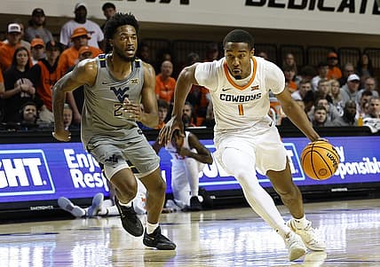 Jan 2, 2023; Stillwater, Oklahoma, USA; Oklahoma State Cowboys guard Bryce Thompson (1) drives to the basket ahead of West Virginia Mountaineers guard Kobe Johnson (2) during the first half at Gallagher-Iba Arena. Mandatory Credit: Alonzo Adams-USA TODAY Sports
