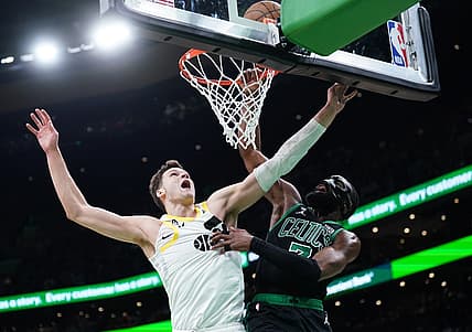 Mar 31, 2023; Boston, Massachusetts, USA; Boston Celtics guard Jaylen Brown (7) makes the basket against Utah Jazz center Walker Kessler (24) in the second quarter at TD Garden. Mandatory Credit: David Butler II-USA TODAY Sports