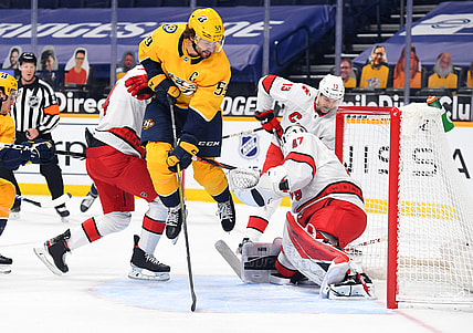 Mar 2, 2021; Nashville, Tennessee, USA; Nashville Predators defenseman Roman Josi (59) jumps after having a shot blocked by Carolina Hurricanes goaltender James Reimer (47) during the first period at Bridgestone Arena. Mandatory Credit: Christopher Hanewinckel-USA TODAY Sports