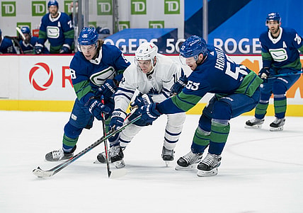 Mar 6, 2021; Vancouver, British Columbia, CAN; Vancouver Canucks forward Adam Gaudette (96) and  forward Bo Horvat (53) check Toronto Maple Leafs forward  Zach Hyman (11) in the third period at Rogers Arena. Canucks won 4-2. Mandatory Credit: Bob Frid-USA TODAY Sports
