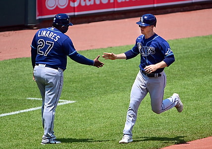 May 20, 2021; Baltimore, Maryland, USA; Tampa Bay Rays shortstop Joey Wendle (18) high fives third base coach Rodney Linares (27) after hitting a home run in the second inning against the Baltimore Orioles at Oriole Park at Camden Yards. Mandatory Credit: Evan Habeeb-USA TODAY Sports