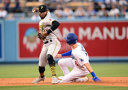 Aug 16, 2021; Los Angeles, California, USA; Los Angeles Dodgers shortstop Trea Turner (6) is out at second as Pittsburgh Pirates second baseman Rodolfo Castro (64) throws to first for the out against first baseman Albert Pujols (55) during the first inning at Dodger Stadium. Mandatory Credit: Gary A. Vasquez-USA TODAY Sports