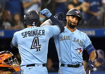 Oct 3, 2021; Toronto, Ontario, CAN;  Toronto Blue Jays center fielder George Springer (4) is greeted by second baseman Marcus Semen (10) after hitting a solo home run in the first inning at Rogers Centre. Mandatory Credit: Dan Hamilton-USA TODAY Sports