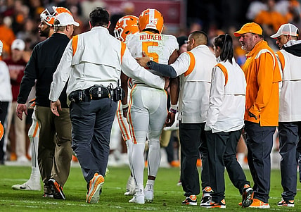 Nov 19, 2022; Columbia, South Carolina, USA; Tennessee Volunteers quarterback Hendon Hooker (5) is assisted off the field after suffering an apparent injury against the South Carolina Gamecocks in the second half at Williams-Brice Stadium. Mandatory Credit: Jeff Blake-USA TODAY Sports