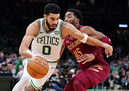Dec 12, 2023; Boston, Massachusetts, USA; Boston Celtics forward Jayson Tatum (0) drives the ball against Cleveland Cavaliers guard Donovan Mitchell (45) in the second half at TD Garden. Mandatory Credit: David Butler II-USA TODAY Sports