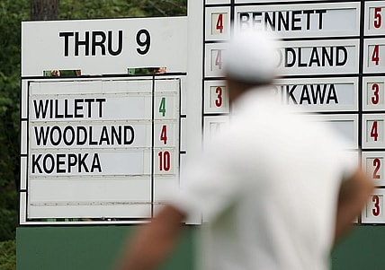 Brooks Koepka checks the scoreboard on no. 10 during the second round of The Masters golf tournament.