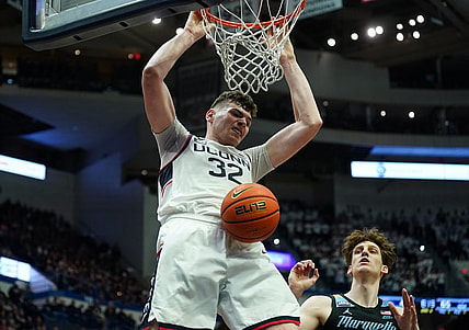 Feb 17, 2024; Hartford, Connecticut, USA; UConn Huskies center Donovan Clingan (32) makes the basket against the Marquette Golden Eagles in the second half at XL Center. Mandatory Credit: David Butler II-USA TODAY Sports