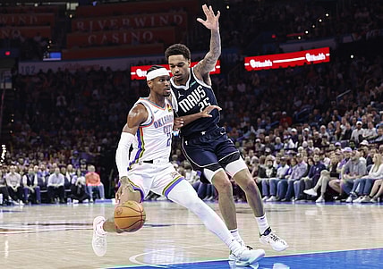 Mar 14, 2024; Oklahoma City, Oklahoma, USA; Oklahoma City Thunder guard Shai Gilgeous-Alexander (2) drives to the basket beside Dallas Mavericks forward P.J. Washington (25) during the second half at Paycom Center. Mandatory Credit: Alonzo Adams-USA TODAY Sports