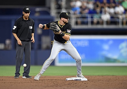 Mar 28, 2024; Miami, Florida, USA;  Pittsburgh Pirates second baseman Jared Triolo drops the ball while trying to turn a double play during the second inning against the Miami Marlins, at loanDepot Park. Mandatory Credit: Michael Laughlin-USA TODAY Sports