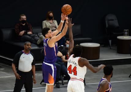 Mar 31, 2021; Phoenix, Arizona, USA; Phoenix Suns guard Devin Booker (1) shoots over Chicago Bulls forward Patrick Williams (44) during the second half at Phoenix Suns Arena. Mandatory Credit: Joe Camporeale-USA TODAY Sports